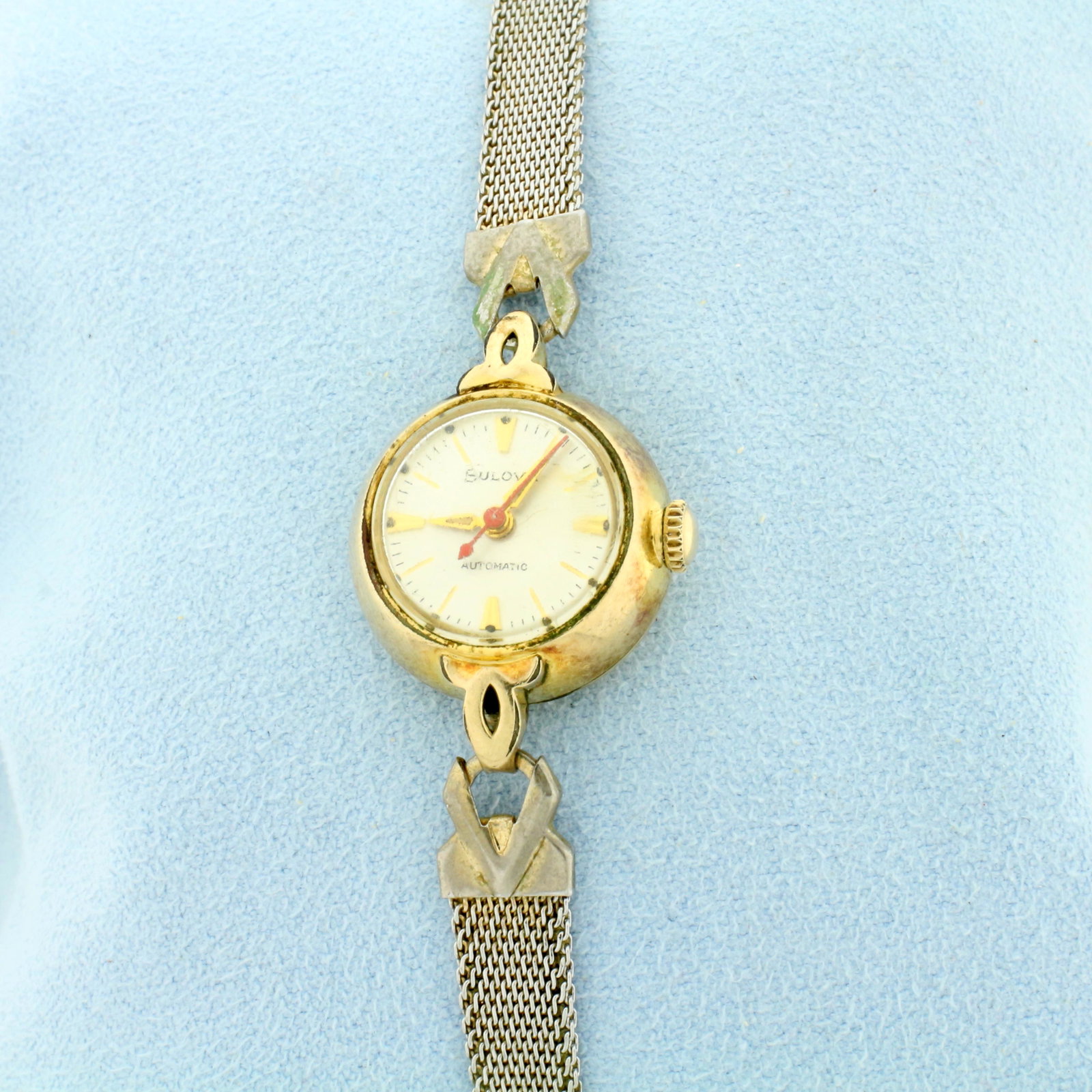 Antique Womans Bulova Automatic Watch: Case is 10k gold plated, band is stainless steel. Automatic movement runs great. Water resistant and anti-magnetic. Case is 16mm.