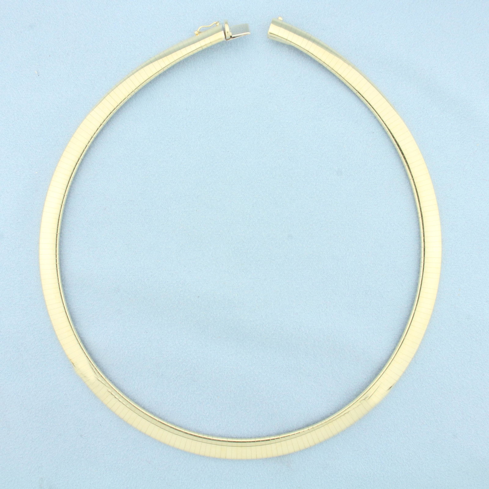 Italian Omega Necklace in 14k Yellow Gold: In 14k yellow gold. 16 inches long, 8mm wide. Slide clasp with safety latch. 49.8g.