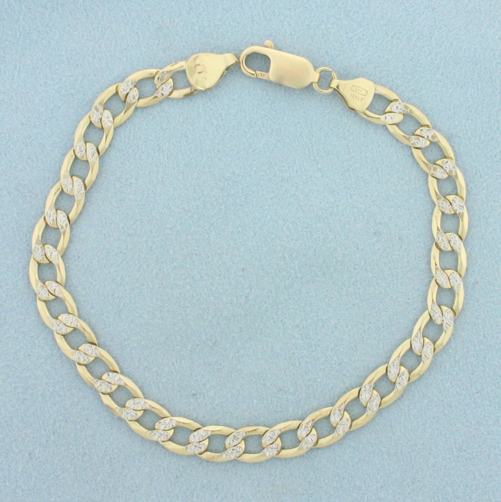 Diamond Illusion Curb Link Bracelet in 10k Yellow and White Gold: In 10k yellow and white gold. 8 inches long, 6mm wide. Diamond Cut white gold on links gives illusion of diamond studded links. Lobster clasp. 7.8g.
