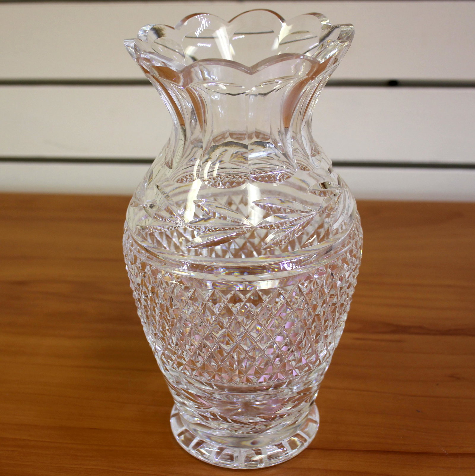 Retired Waterford Crystal Glandore 9 Inch Flower Vase: 9 inches high, 4 1/4 inch diameter at top. Blown glass cut Irish Crystal. Scalloped rim detail. Excellent condition. Old Gothic acid watermark etching of Waterford.