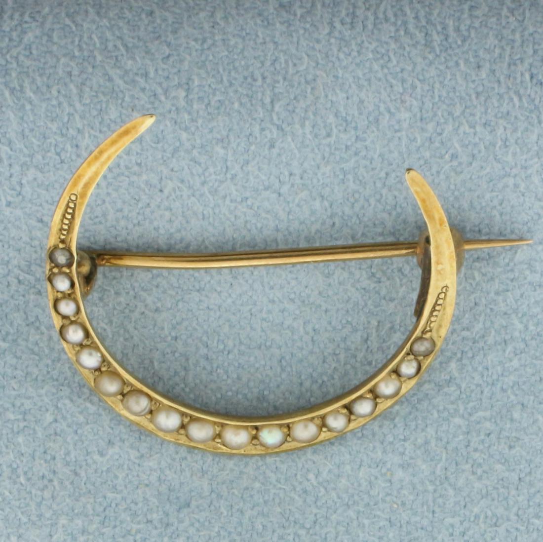 Antique Victorian Crescent Moon Brooch Pin in 14k Yellow Gold: In 14k yellow gold. Sometimes referred to as a "honeymoon brooch", this late Victorian or early Edwardian brooch is lined with 1.8mm seed pearls. 7/8 inch diameter. 1.9g.