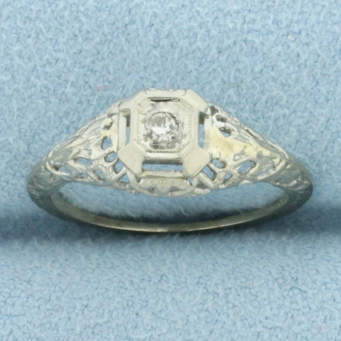 Art Deco Antique Filigree Ring In 18k White Gold: In 18k white gold. Contains one .07ct high quality Old European Cut diamond, SI clarity/H color. Extensive engravings on knife edge shoulders as well as milgrain detailing. In excellent condition for