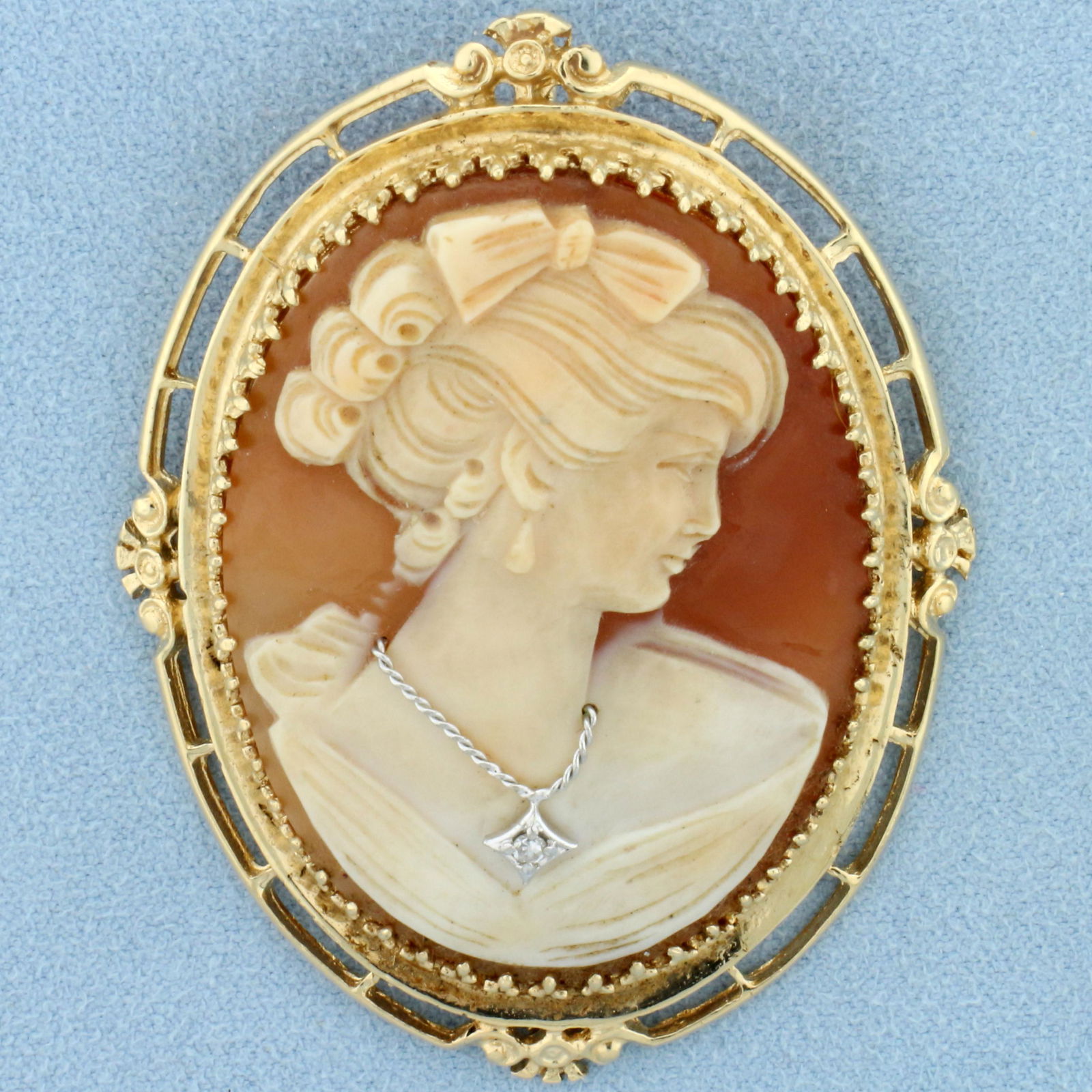 Large Vintage Diamond Shell Cameo Pendant or Pin in 14k Yellow Gold: In 14k yellow gold. Can be worn as pendant or pin/brooch. Features carved shell profile Victorian woman cameo with a .02ct single cut diamond in necklace. Measures 2 3/8 inch high by 1 3/4" inch wide.
