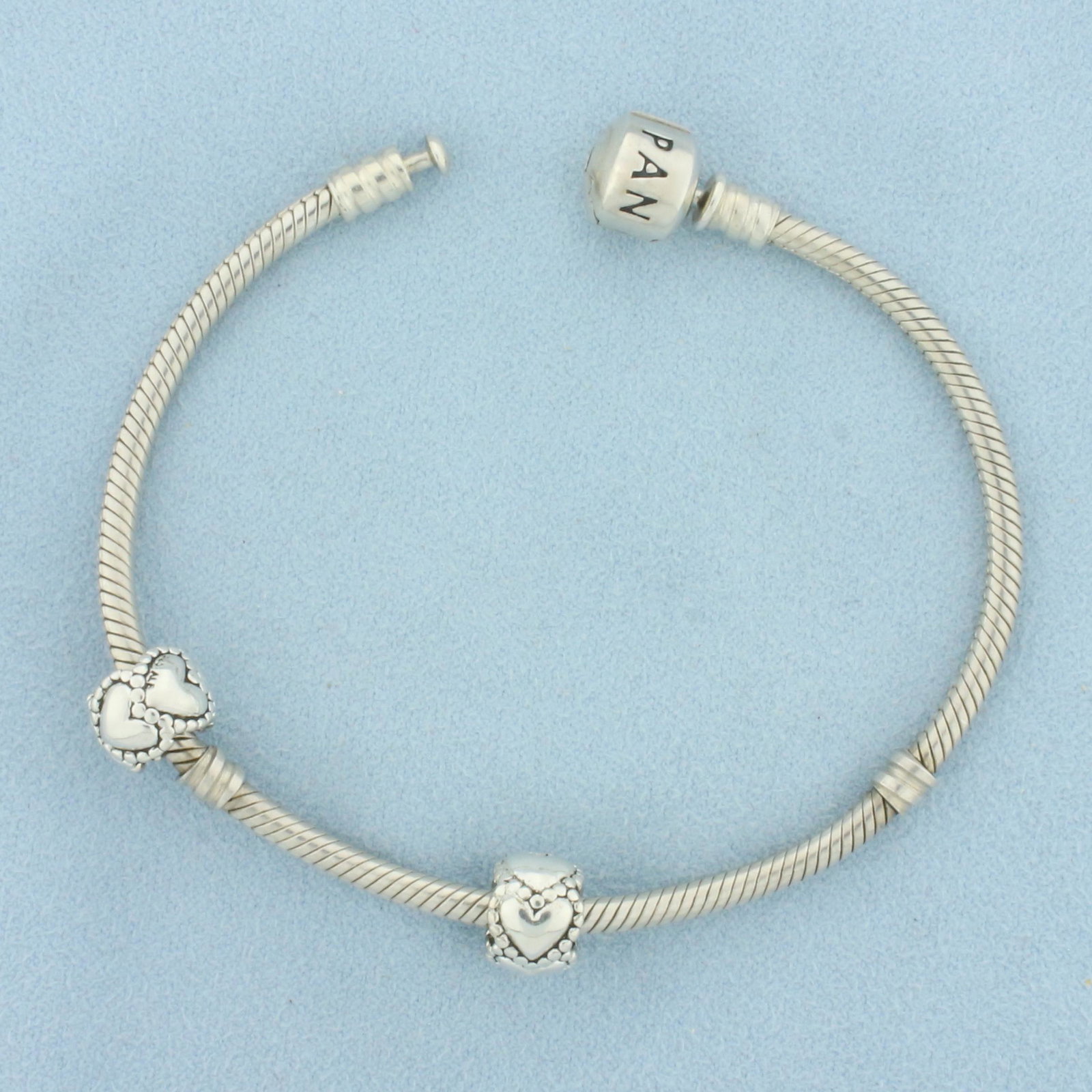 Pandora Moments Sterling Silver Snake Chain Bracelet With Charms: In .925 sterling silver. Guaranteed authentic. Great Starter bracelet include 2 authentic pandora hearts charms (retired ). 7 1/4 Inches long.