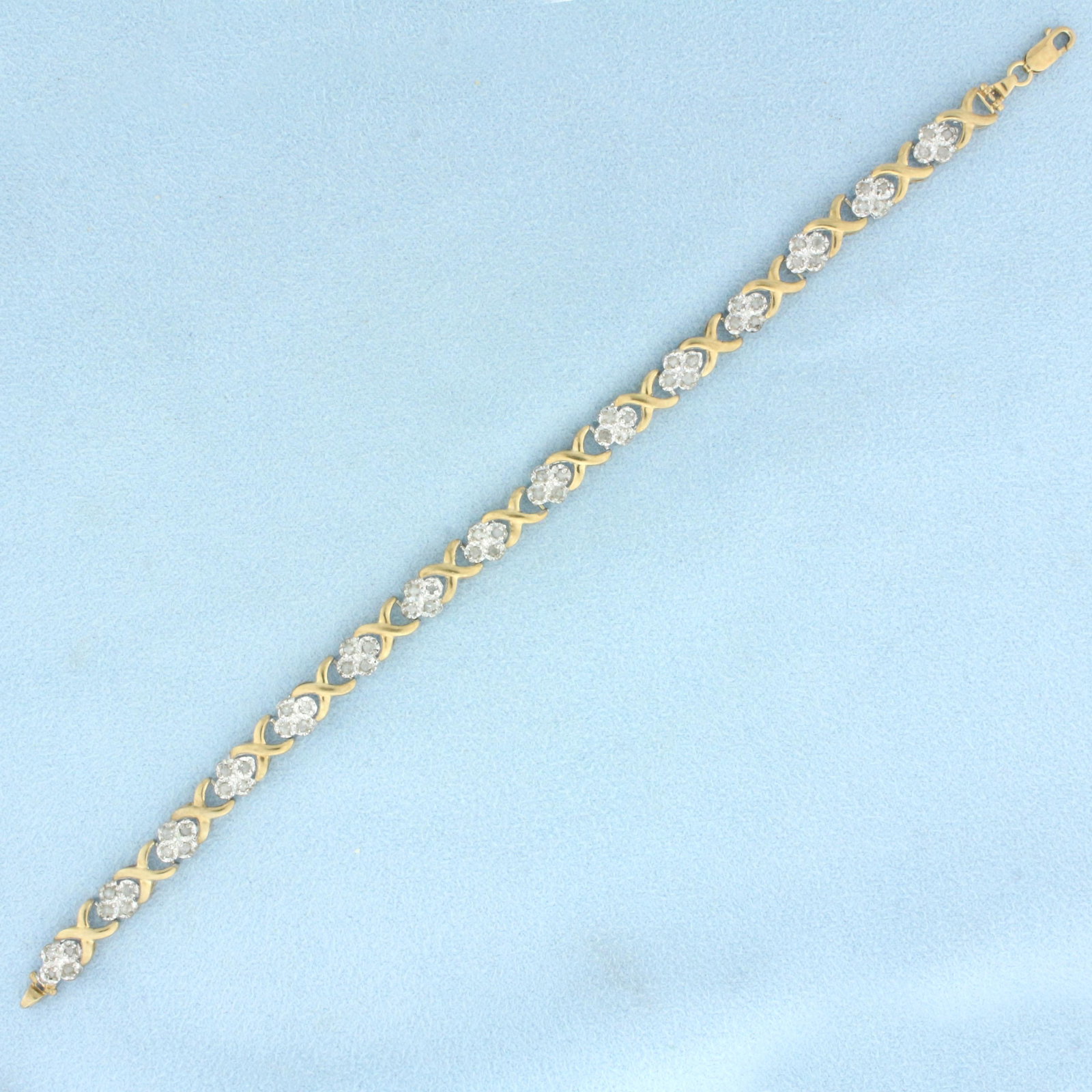 Diamond X Link Bracelet in 10k Yellow Gold: In 10k yellow gold. Contains sixty .01ct diamonds, H color/I clarity. Lobster clasp. 6.6g.