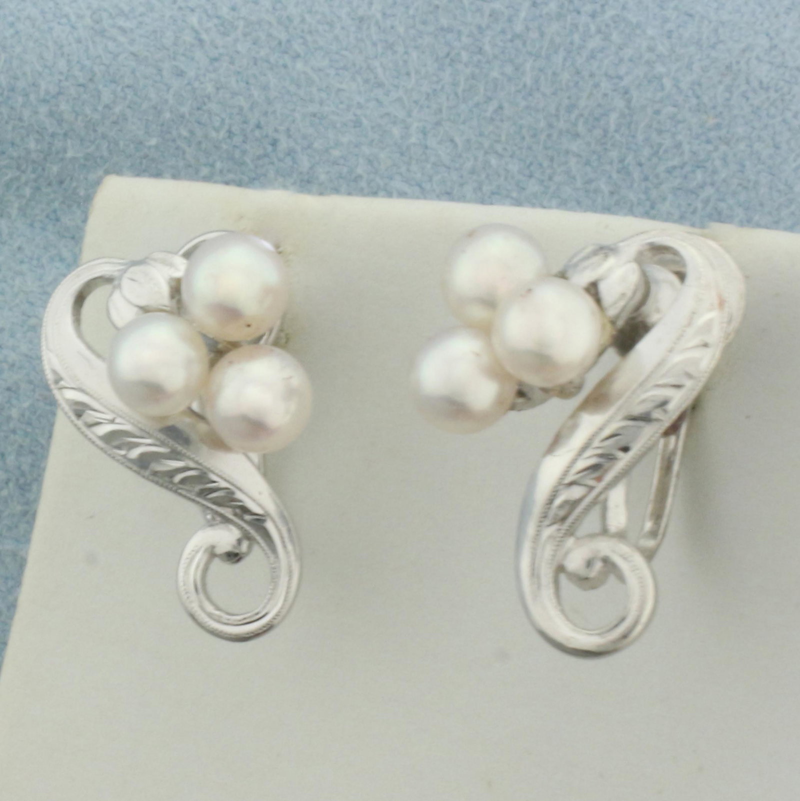Mikimoto Art Deco Akoya Pearl Screw back Earrings in .925 Sterling Silver: In .925 sterling silver. Contains 6 high quality cultured akoya pearls with excellent luster and pink undertone. 4.5mm each. Includes original box