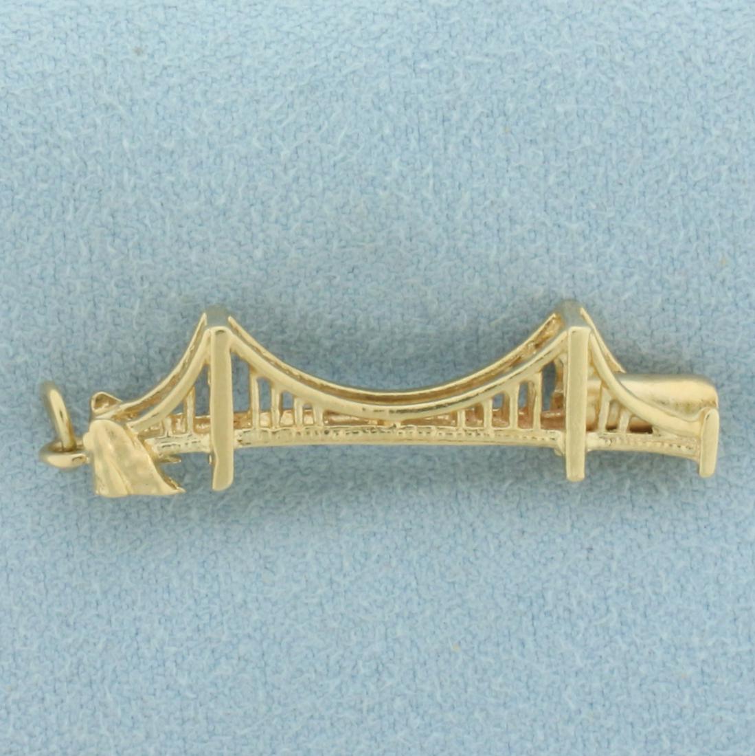 Golden Gate Bridge Charm or Pendant in 14k Yellow Gold: In 14k yellow gold. 1 3/8 inches long (Including jump ring) by 5/16inches wide. Unique 3D design. 2.8g.