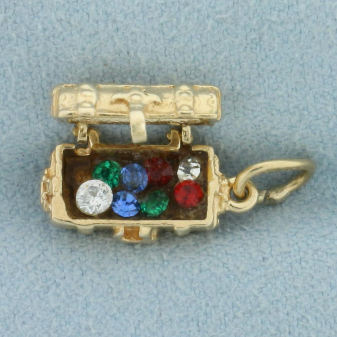 Vintage Pirate Treasure Chest Mechanical Charm in 14k Yellow Gold: In 14k yellow gold. Contains colorful synthetic ruby, sapphire, and diamond gemstones. Chest opens/closes. 3/4 inch long, 1/4 inch wide. 2.4g.