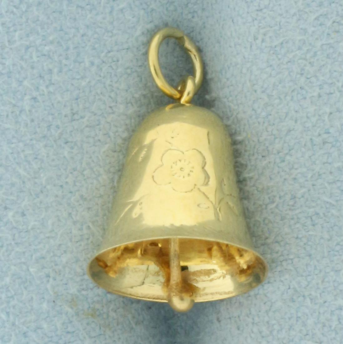 Vintage Engraved Ringing Bell Charm in 14k Yellow Gold: In 14k yellow gold. Approx. 3/4 inches long (including jump ring) x 3/8 inches wide. Bell is 3-D and has movable, working clapper that makes chime sound. Also has intricate engraved flower design. 1.0