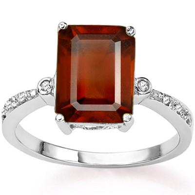 4CT Garnet and Diamond Ring in Sterling Silver: Emerald cut 4.1ct garnet gemstone ring accented with .01ctw genuine diamonds. Size 7. Set in platinum over sterling silver, 2.7g.