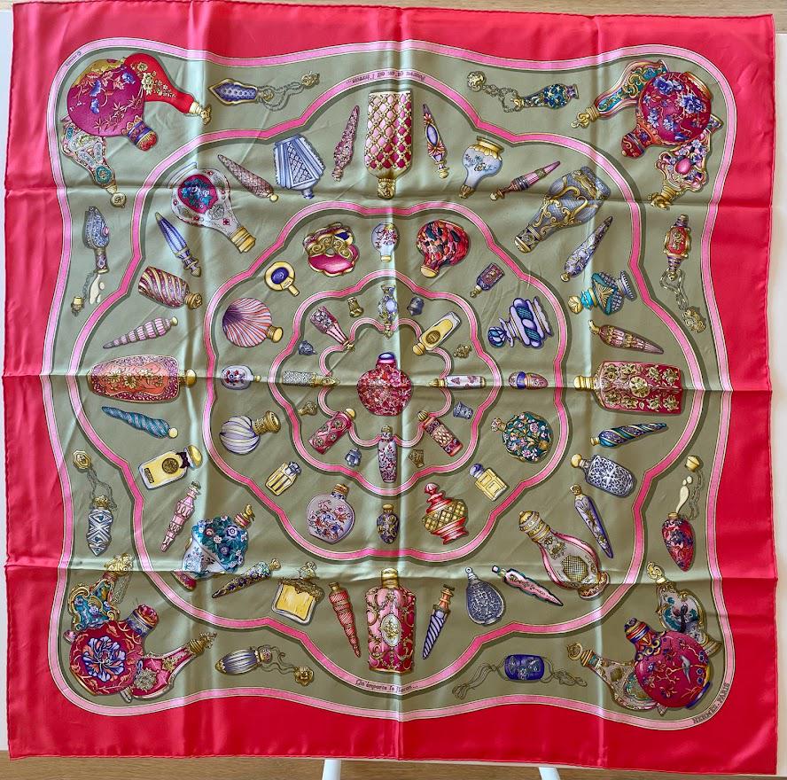 Hermes Pourvu Qu'On Ait L'Ivresse Carre 90 Perfume Bottle Silk Scarf: Guaranteed authentic. Hermes 35" x 35" (90cm) vintage scarf in bold colors. Made in France, 100% silk, hand rolled edges. Created by Catherine Baschet with a loose translation / meaning of "pour, what