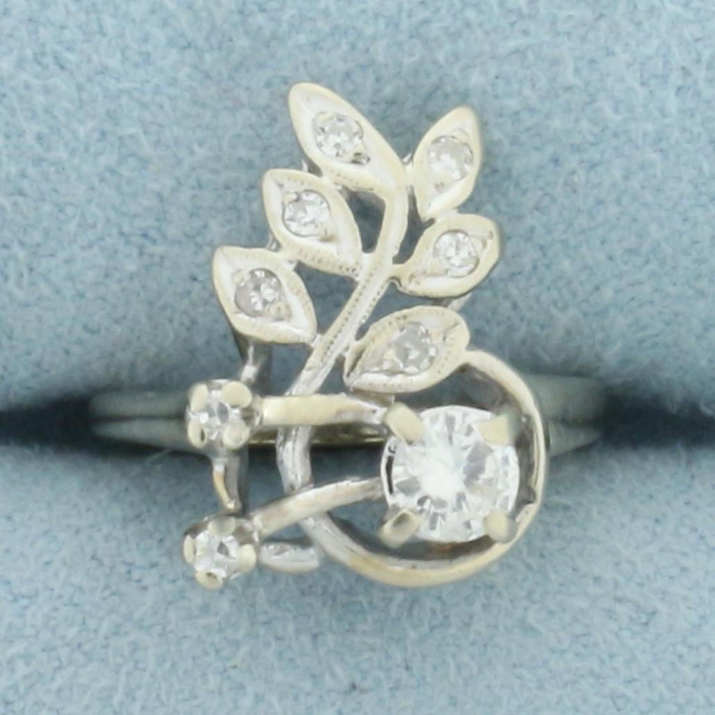 Retro Diamond Leaf Ring in 14k White Gold: In 14k white gold. Contains one 1/4ct high quality round brilliant diamond, VS clarity/G color. Also contains two .01ct and four 1/2pt diamonds of similar high quality. Size 2. 3.3g.