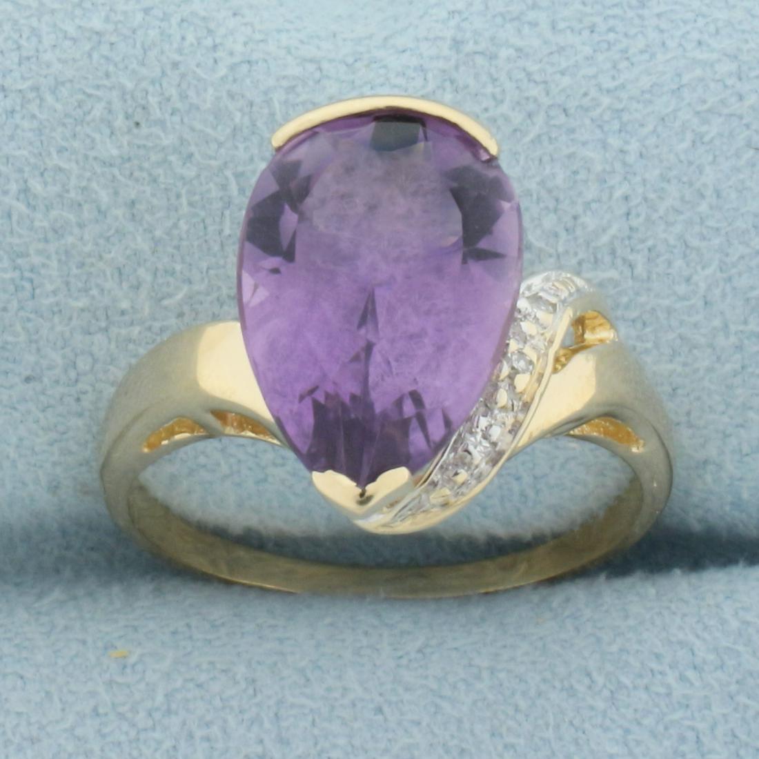 Amethyst and Diamond Ring in 14k Yellow Gold: In 14k yellow gold. Contains one high quality natural 14x9mm Amethyst pear cut gemstone, Approximately 5cts, with vibrant color and excellent clarity. Accented by three half point diamonds. Size: 8. 3