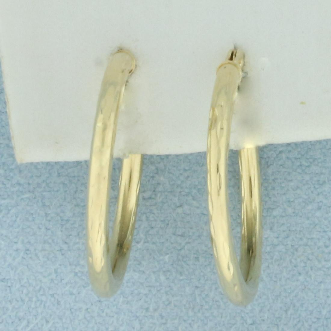 Diamond Cut Beveled Hoop Earrings in 14k Yellow Gold: In 14k yellow gold. 3/4 inch hoops, 2mm wide. Diamond cut beveled design for more sparkle. .9g.