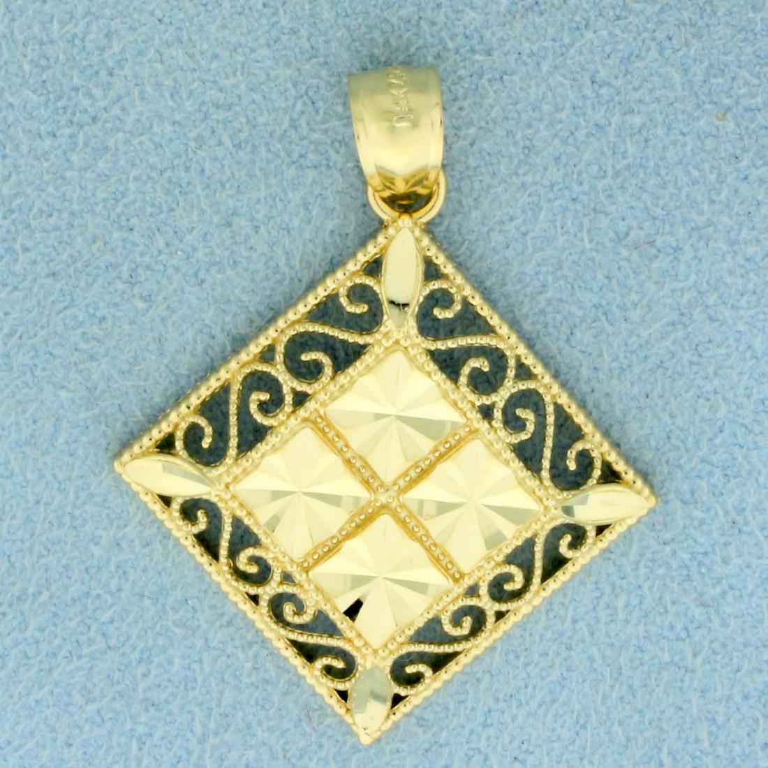 Diamond Cut Filigree Design Pendant in 14K Yellow Gold: In 14K Yellow Gold. 1 1/2 inches long including bale. 1 inch wide. Diamond cut for sparkle look. 2.6g
