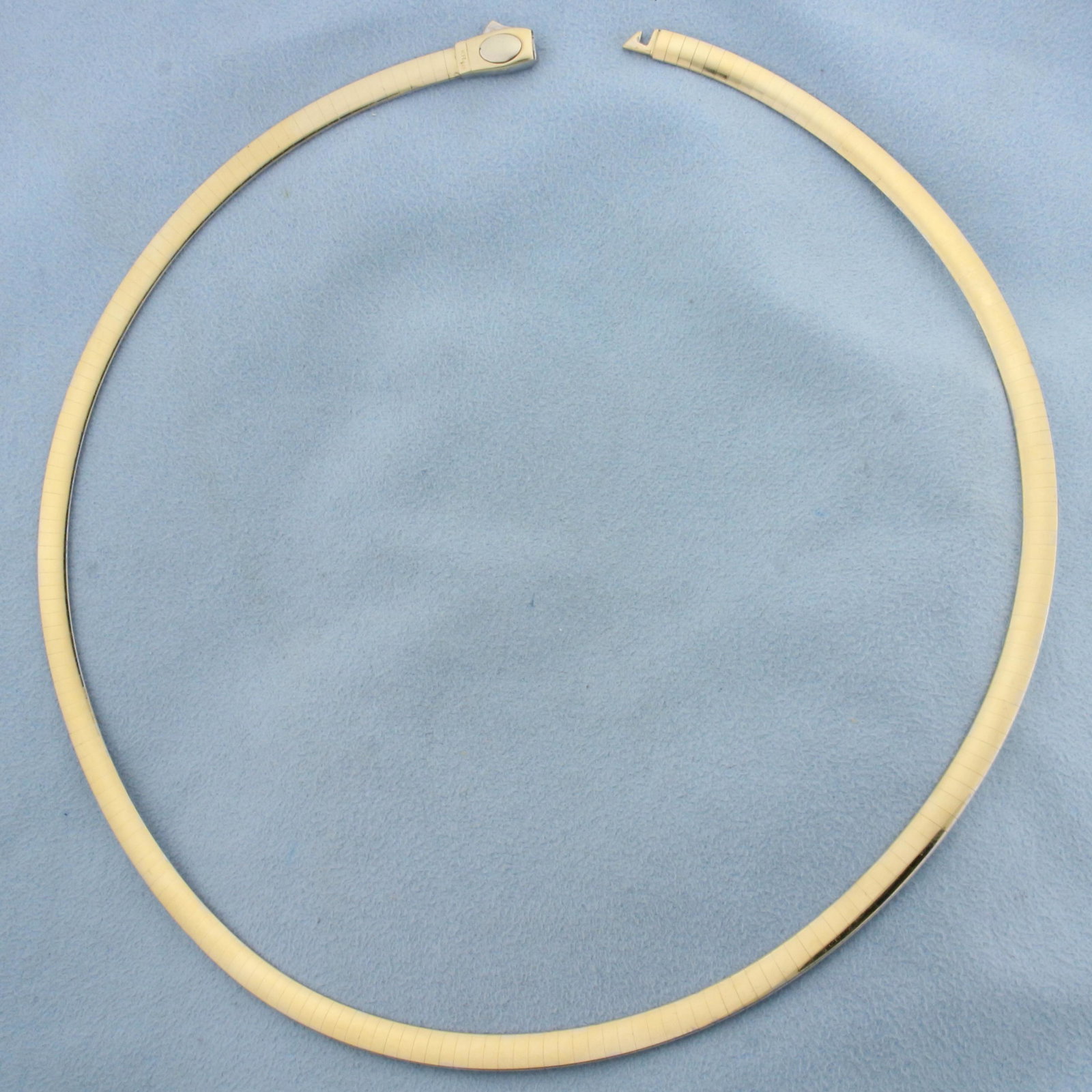 18 Inch Reversible Omega Necklace in 14K Yellow and White Gold: In 14K Yellow and White Gold. 18 inches long and 5mm wide. White Gold on one side, yellow gold on other side. 25.6g