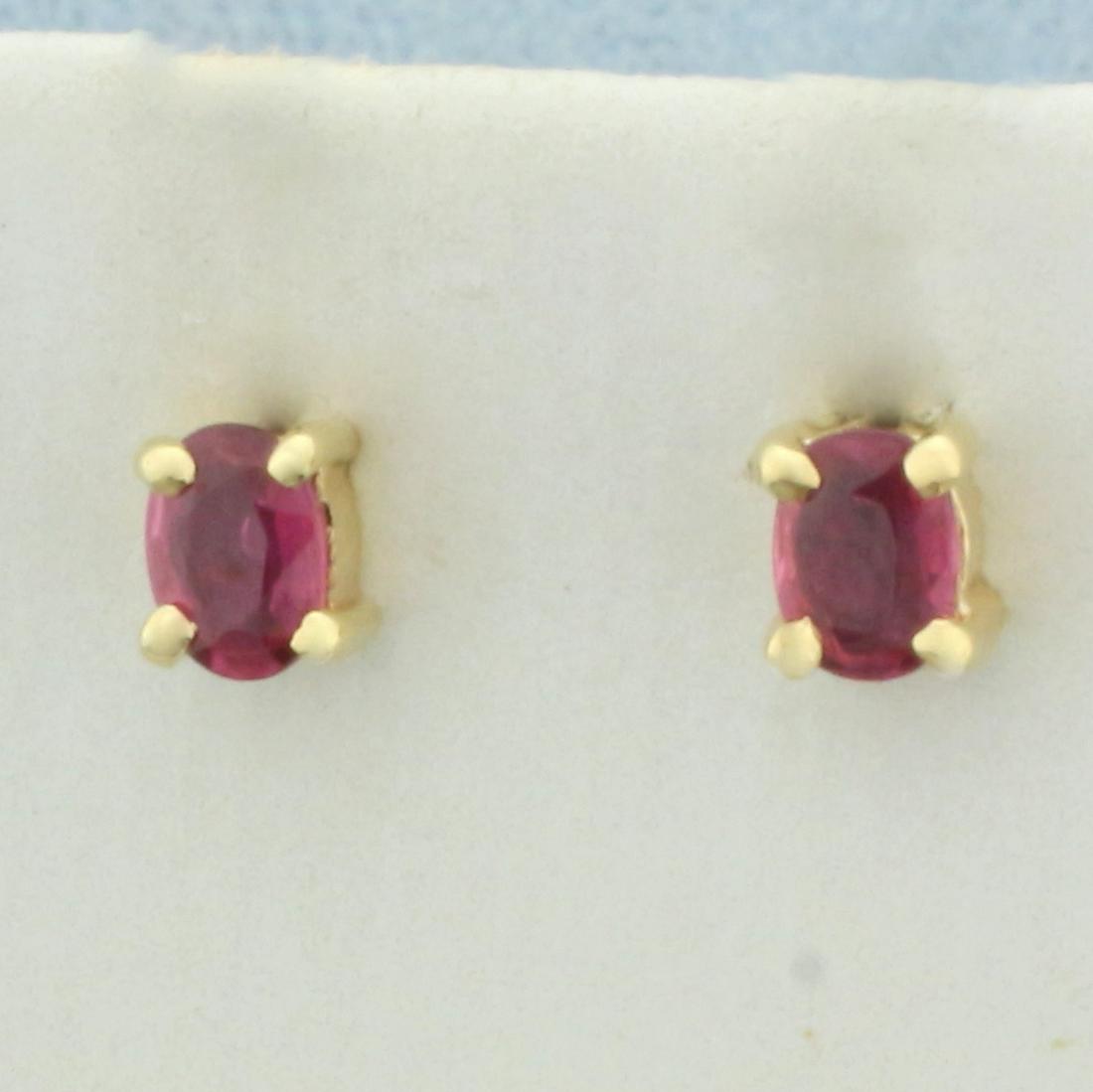 Natural Ruby Stud Earrings in 14k Yellow Gold: In 14k yellow gold. Contains two high quality natural 1/8ct oval shaped Ruby gemstones with vibrant color. Friction backs. 1.0g.