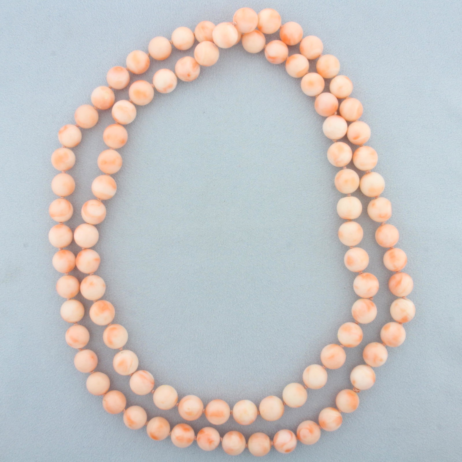 36 Inch Angel Skin Pink Coral Bead Strand Necklace: 36 inches long. Contains 10mm high polished angel skin coral beads with beautiful pink color. Hand Knotted on tonal thread.