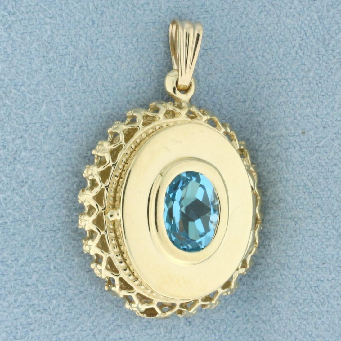 Blue Topaz Locket Pendant in 14k Yellow Gold: In 14k yellow gold. Contains one high quality natural oval cut blue topaz gemstone, 8mm by 10mm, with bright color and excellent clarity. Opens to reveal interior compartment for photo other item. 1 1