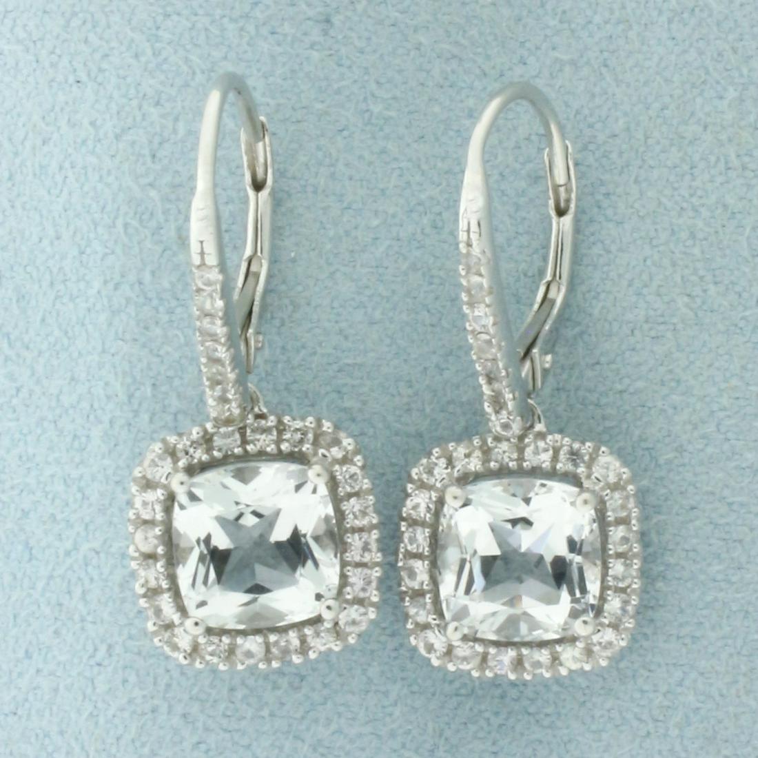 White Sapphire Halo Drop Dangle Earrings in 14k White Gold: In 14k white gold. Contains 2-cushion cut 7mm high quality White Sapphire gemstones with excellent clarity. Accented with 54 round sapphires of similar high quality. Lever backs for pierced ears. 4.0g
