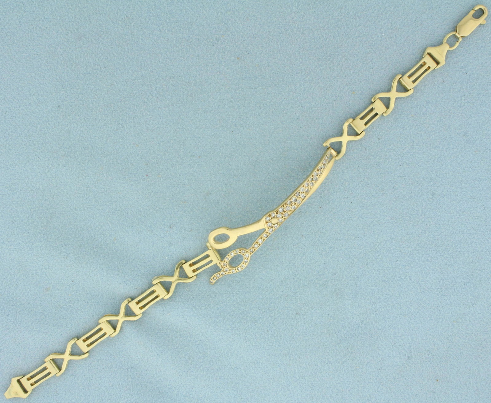 Vintage Diamond Scissor Seamstress Bracelet in 14K Yellow Gold: In 14K Yellow Gold. Contains forty six high quality Diamonds, 1/2ct TW, SI clarity/H color. 7 inches long. Scissors are 14mm wide. 10.4g