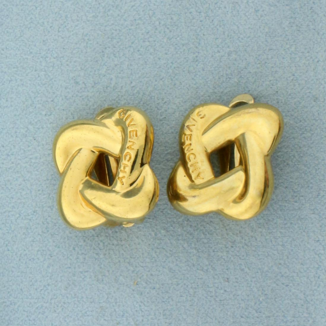 Vintage Designer Givenchy Logo Knot Clip On Earrings: Gold Plated. 5/8 inches long. Infinity love knot design with 'GIVENCHY' on each earrings. Clip on backs. 9.9g.