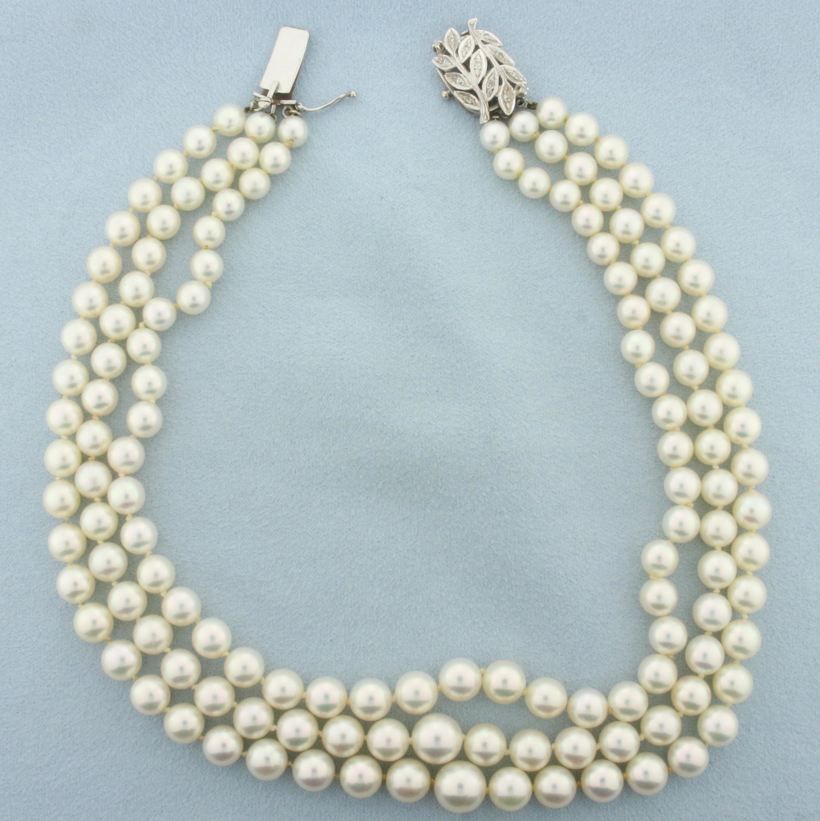 Art Nouveau Diamond Accented Akoya Pearl Triple Strand Choker Collar Necklace in 14k White Gold: 14k white gold clasp. Strands are 14, 14.5 and 15 inches long. Contains 3 strands (hand knotted) of cultured akoya pearls, 5.7mm-8.9mm, with pink undertone and excellent mirror nacre, Accented by sixt