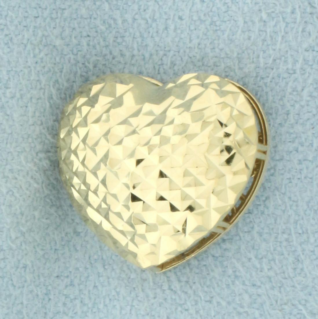 Diamond Cut Puffy Heart Pendant in 14k Yellow Gold: In 14k yellow gold. 5/8 inches wide x 9/16 inches long.