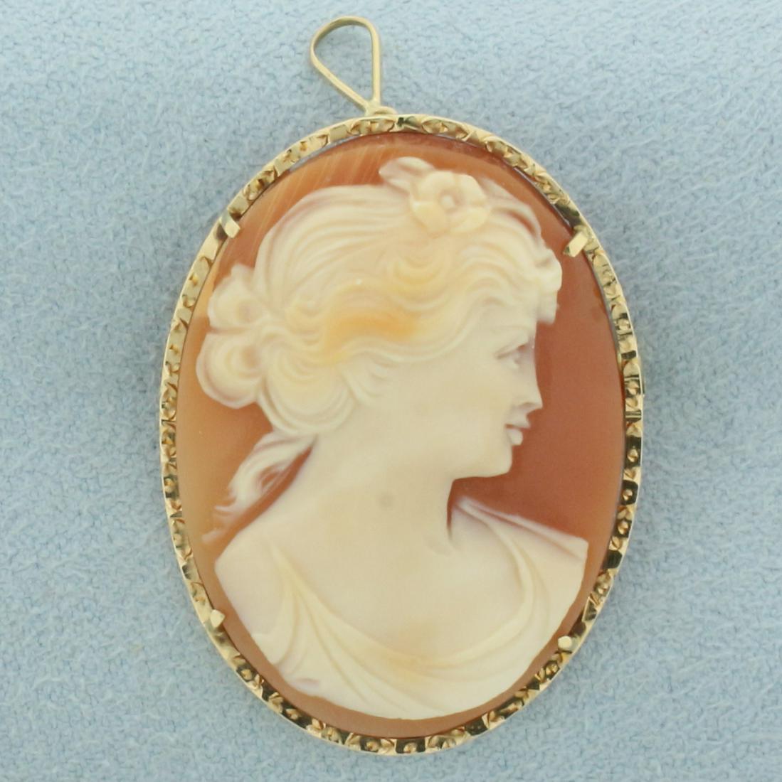 Right Facing Carved Shell Cameo Brooch or Pendant in 14k Yellow Gold: In 14k yellow gold. Italian made. 1.5 inches long (including pendant bale). Can be worn as pendant or pin/brooch. Contains one carved shell right facing female profile cameo. 3.7g.