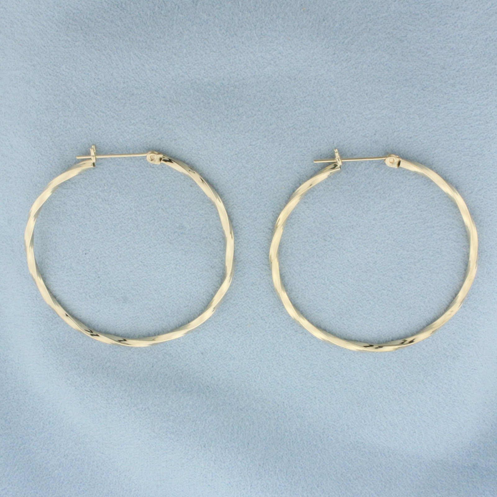 Large Twisting Design Hoop Earrings in 14k Yellow Gold: In 14k yellow gold. 1.5 inches long, 2mm wide. Lever backs. 2.7g.