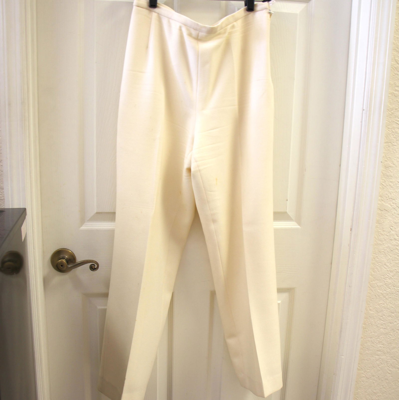 Escada Cream Wool Pants: Size 40. Vintage Escada. 100% new wool. Fully lined with rayon. Side Zip. Vintage condition with stains/imperfections.
