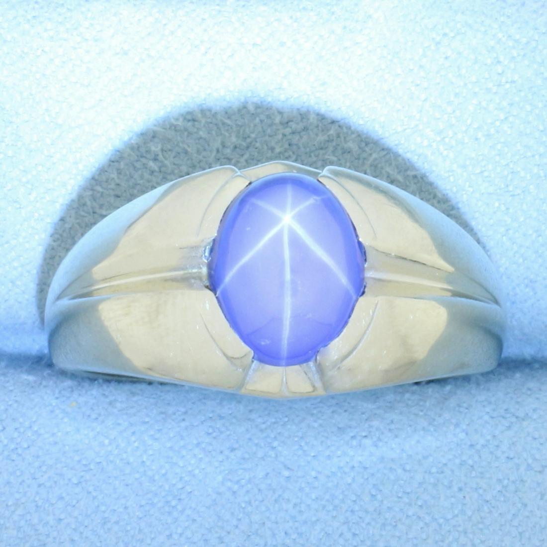 Mens 4ct Star Sapphire Ring in 14k White Gold: In 14k white gold. Contains one oval cabochon star sapphire gemstone, 10mm by 8mm, with distinctive "star" under lighting. Size: 12.75. 8.7g.