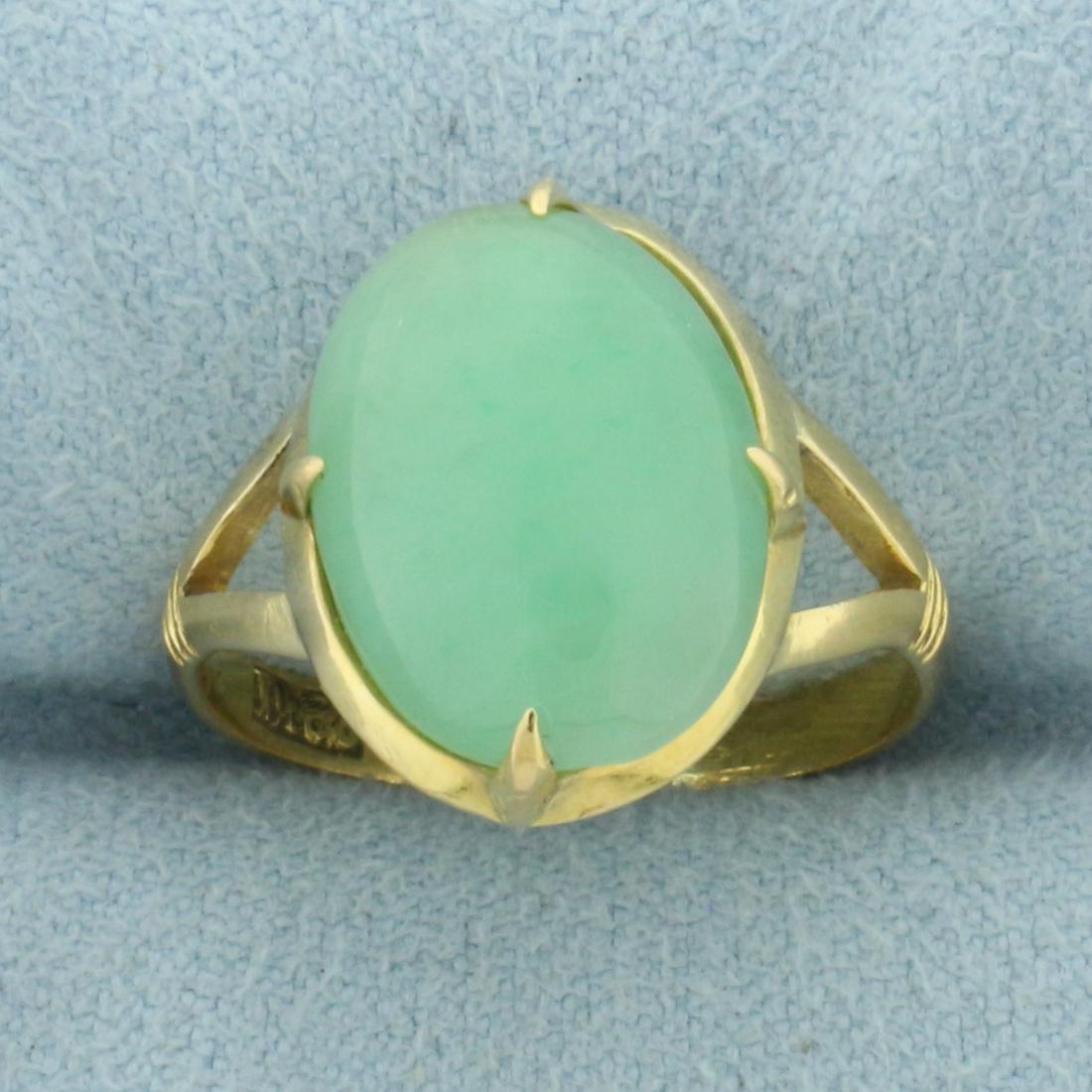 Jade Split Shank Solitaire Ring in 22k Yellow Gold: In 22k yellow gold. Contains a high quality natural 14.4mm by 10.6mm oval jade gemstone with vibrant green color and excellent clarity. Size: 6.5. 4.0g.