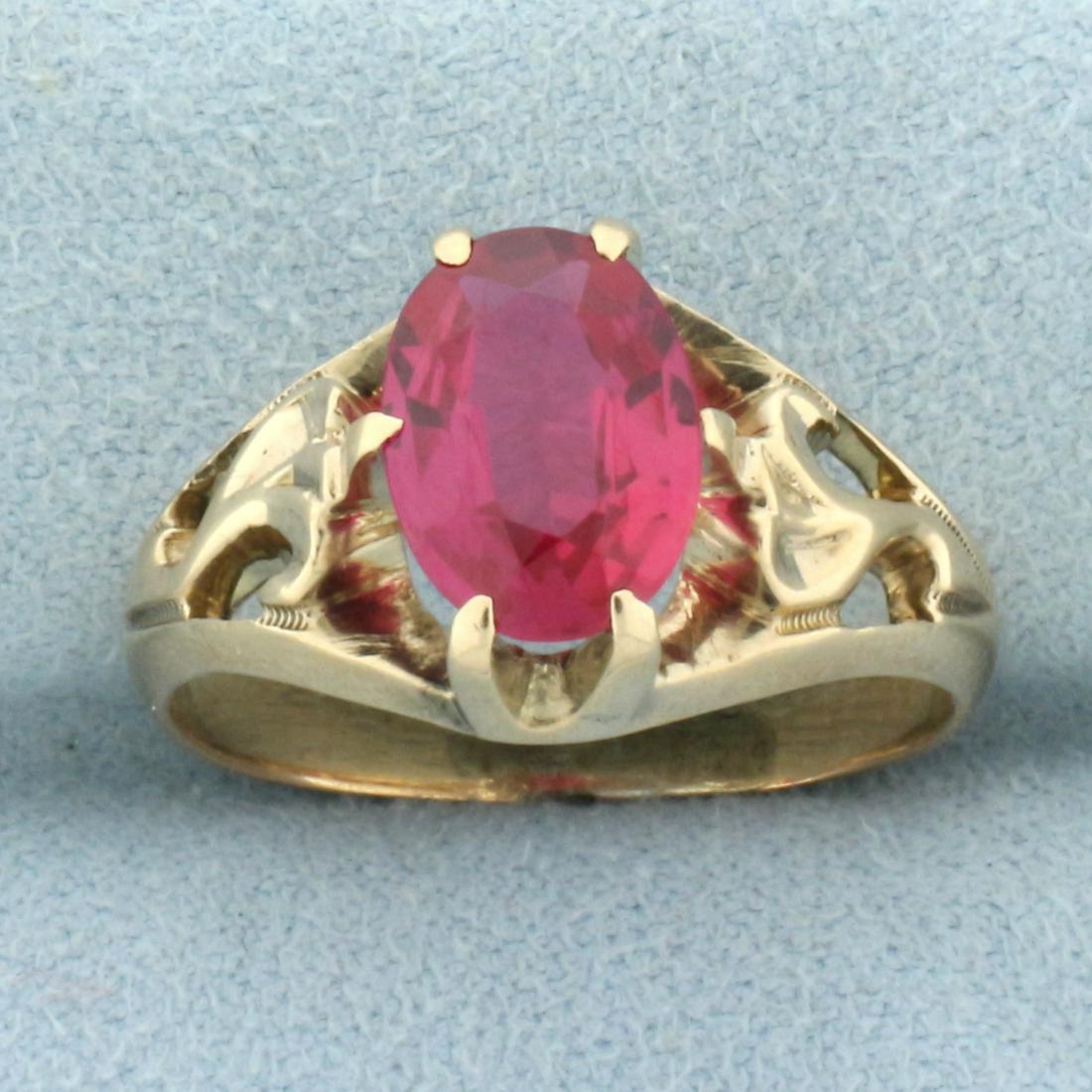 3ct Pink Sapphire Solitaire Ring in 14k Yellow Gold: In 14k yellow gold. Contains one high quality 10mm by 8mm oval cut Pink Sapphire gemstone with intense color and excellent clarity. Size: 8. 4.5g.