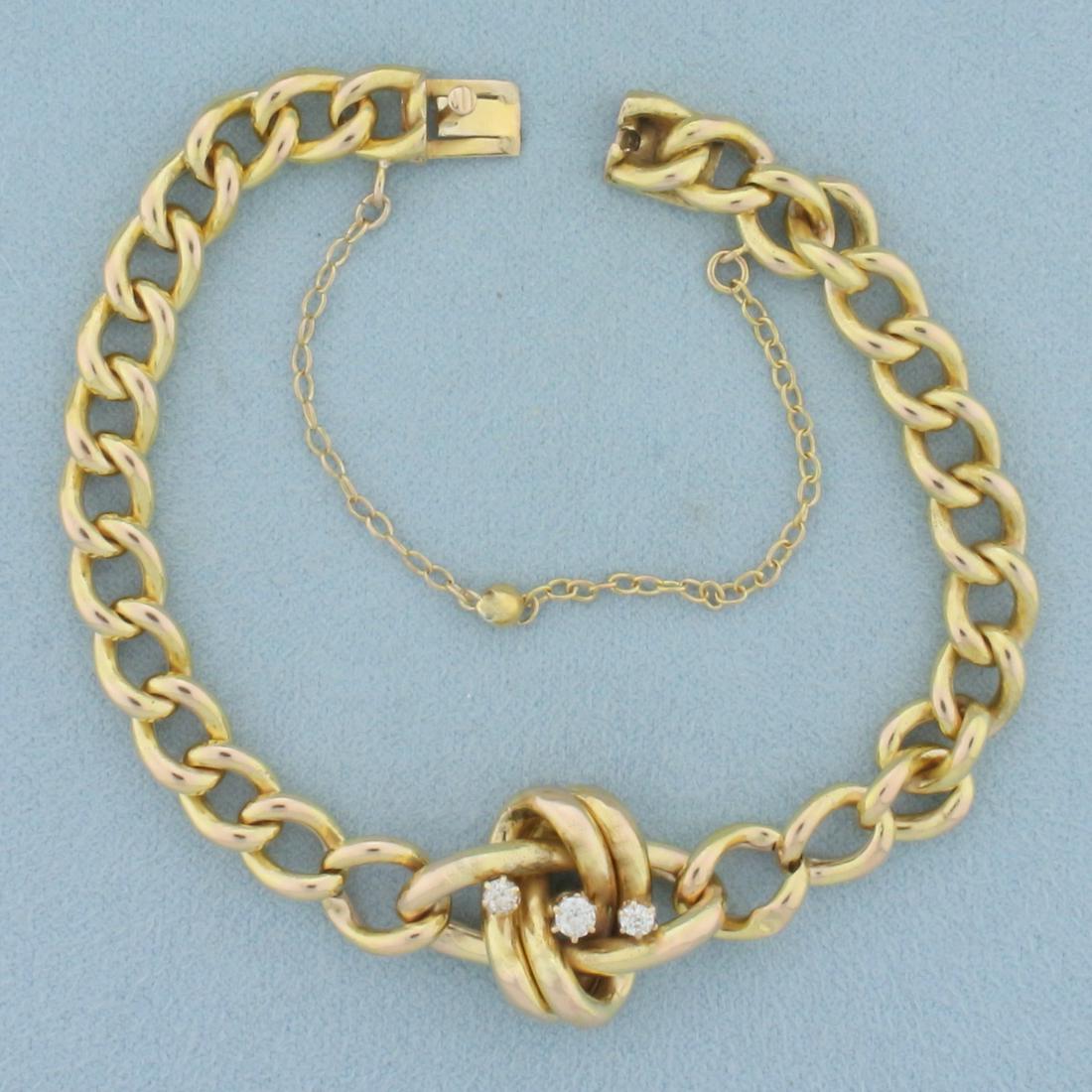 Antique Diamond Knot Design Curb Link Bracelet In 14K Yellow Gold: In 14k yellow gold. Contains one .1ct and two .05ct high quality Old European Cut diamonds, VS clarity/H color . 7 1/4 inches long, 7.2mm wide. Concealed side clasp with safety chain. 12.8g.