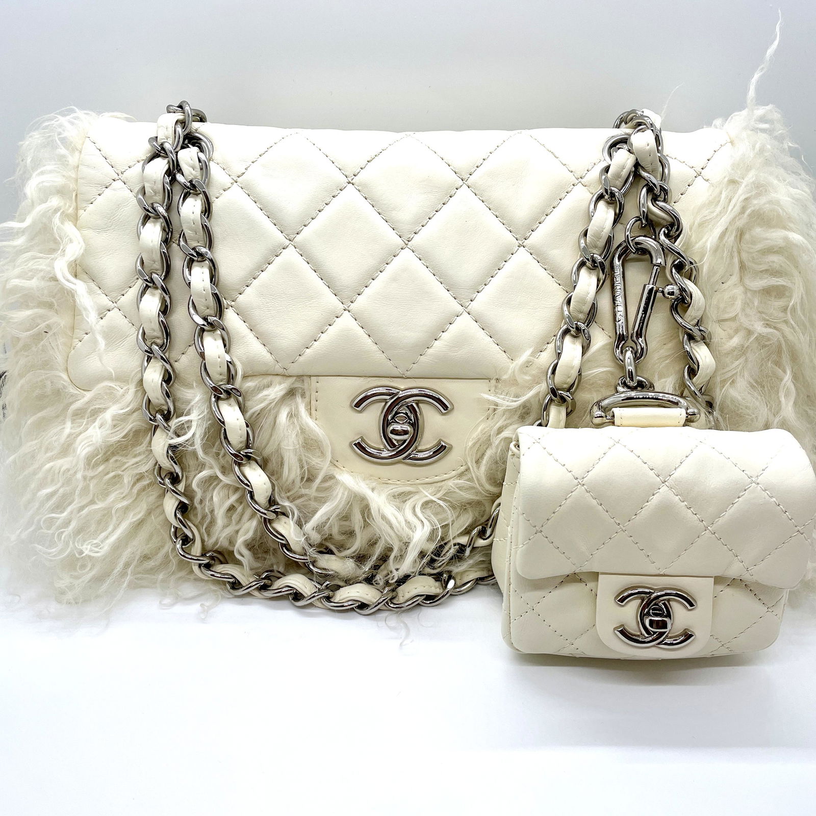 Chanel White Tibet Lambskin Classic Medium Flap Mongolian Fur with Micro Flap Bag: Guaranteed authentic with hologram sticker in bag (#12******). Ultra rare collector's bag set from Karl Lagerfeld. Shiny silver hardware. Iconic CC turnlocks on both bags. Main bag is approx. 11" x 7"
