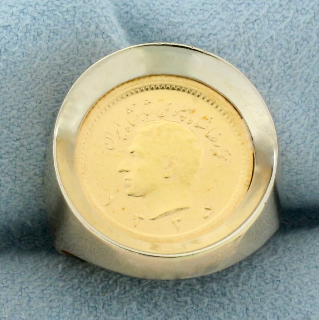 1/4 Pahlavi Gold Coin Ring in 18k Yellow Gold: In 18k yellow gold mounting. Center coin is 90% pure gold Iran 1/4 Pahlavi. Size:7. 9.8g.