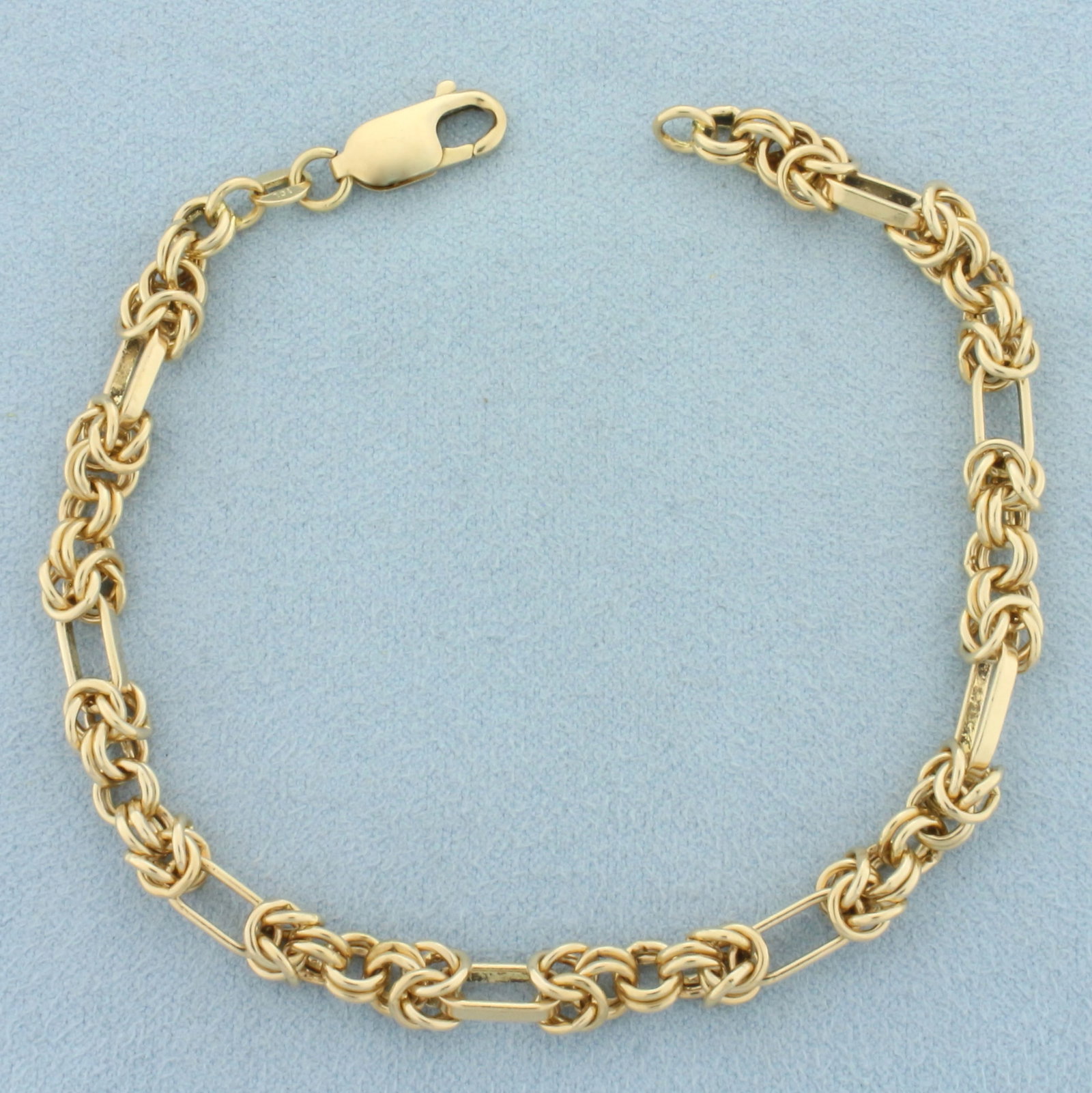 Italian Designer Knot and Oval Link Chain Bracelet in 14k Yellow Gold: In 14k Italian made yellow gold. 8 1/2 inches long, 5mm wide. Lobster clasp. 16.2g.