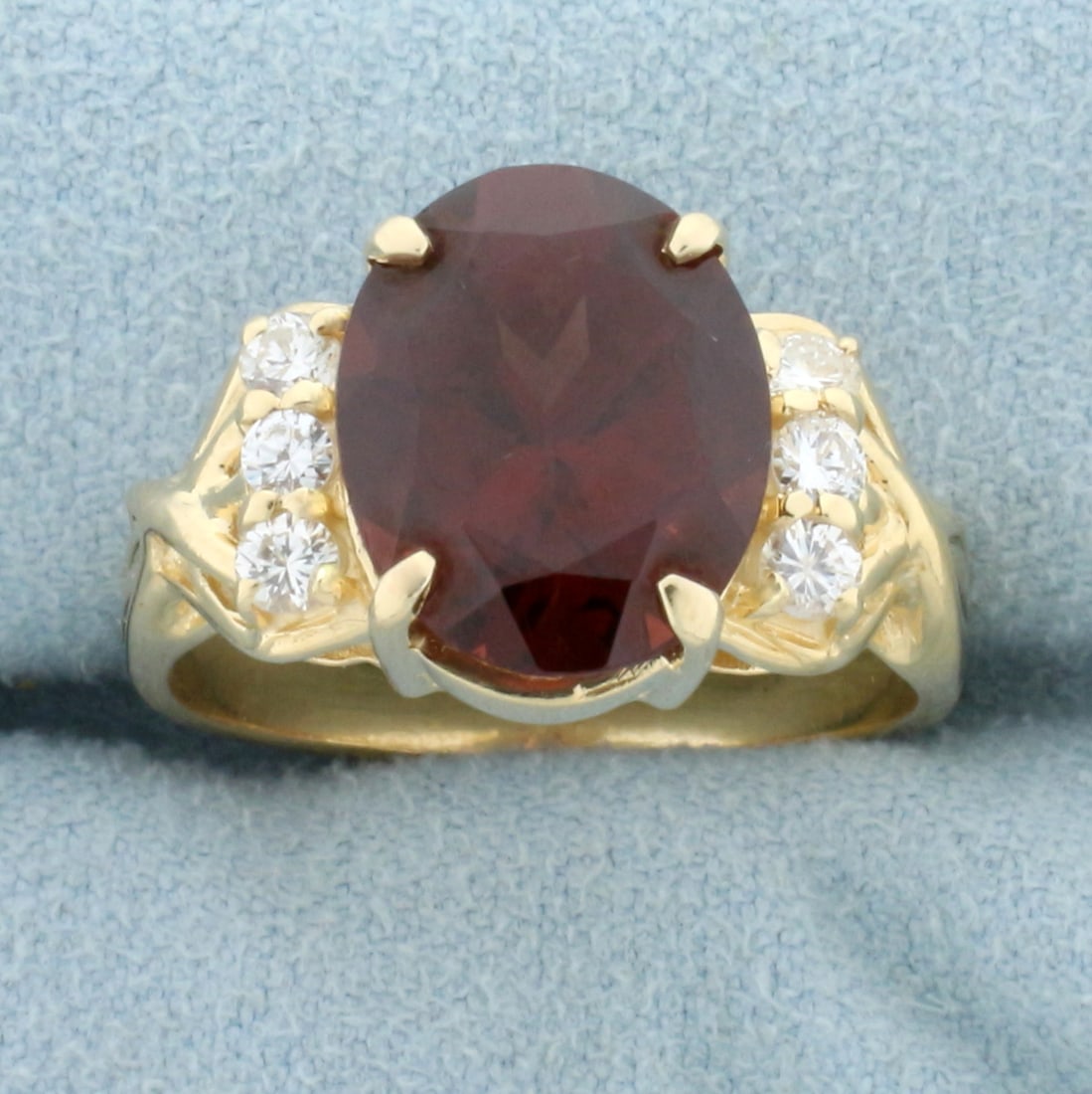 Over 5ct Garnet and Diamond Ring in 14K Yellow Gold: In 14K Yellow Gold. Contains one high quality natural 12x10mm oval cut Garnet gemstone, 5ct, with intense garnet color and excellent clarity. Also contains six high quality .05ct Diamonds, VS clarity/