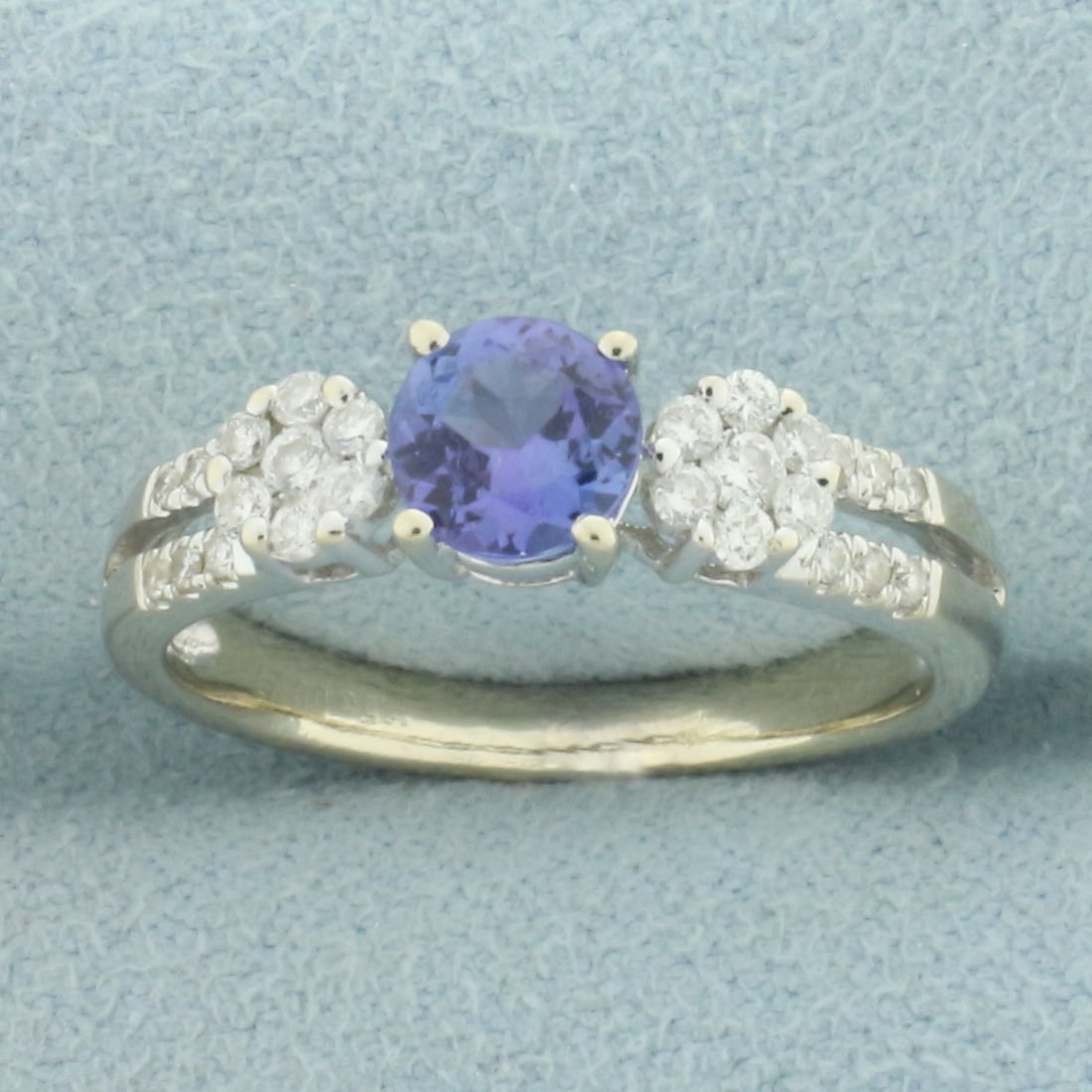 Tanzanite and Diamond Ring in 14k White Gold: In 14k white gold. Contains one 1/2ct high quality Tanzanite gemstone with vibrant color and excellent clarity. Also contains twenty six high quality diamonds, 1/4ct TW, VS clarity/G color. Size: 6.75