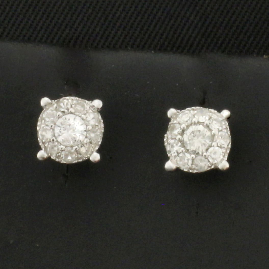 Diamond Halo Stud Earrings in 14k White Gold: In 14k white gold. Contains twenty high quality diamonds, 1/4ct TW, G color/SI1 clarity. Setting gives the appearance of over 1 CTW Diamond stud earrings, but are made up of multiple diamonds. 5.5mm w