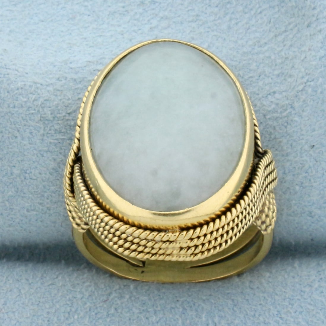 12ct Jade Solitaire Ring in 18K Yellow Gold: In 18K Yellow Gold. Contains one high quality natural 12ct oval Jade gemstone with beautiful grey color and excellent clarity. Size 6 3/4. 11.9g