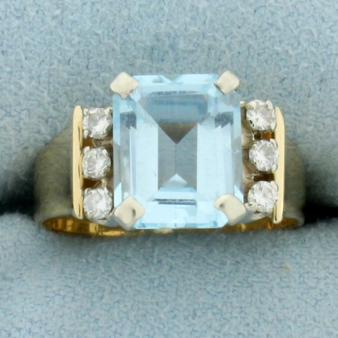 Sky Blue Topaz and Diamond Ring in 14k Yellow Gold: In 14k yellow gold. Contains one 10mm x 8mm Emerald Cut Sky Blue Topaz gemstone with beautiful pastel blue color and excellent clarity . Also contains 6 round brilliant diamonds, 1/4ct TW, SI clarity/