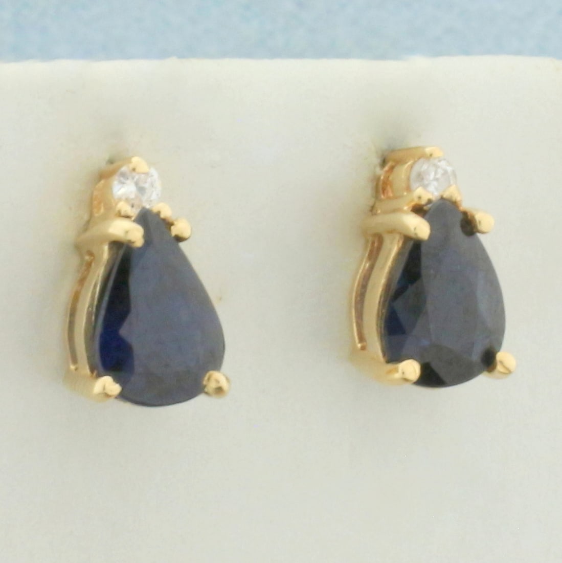 Sapphire and Diamond Stud Earrings in 14k Yellow Gold: In 14k yellow gold. Contains two high quality natural 7mm by 5mm pear shaped sapphire gemstones with deep blue color. Also contains two .02ct high quality diamonds, SI clarity/H color. Friction backs.