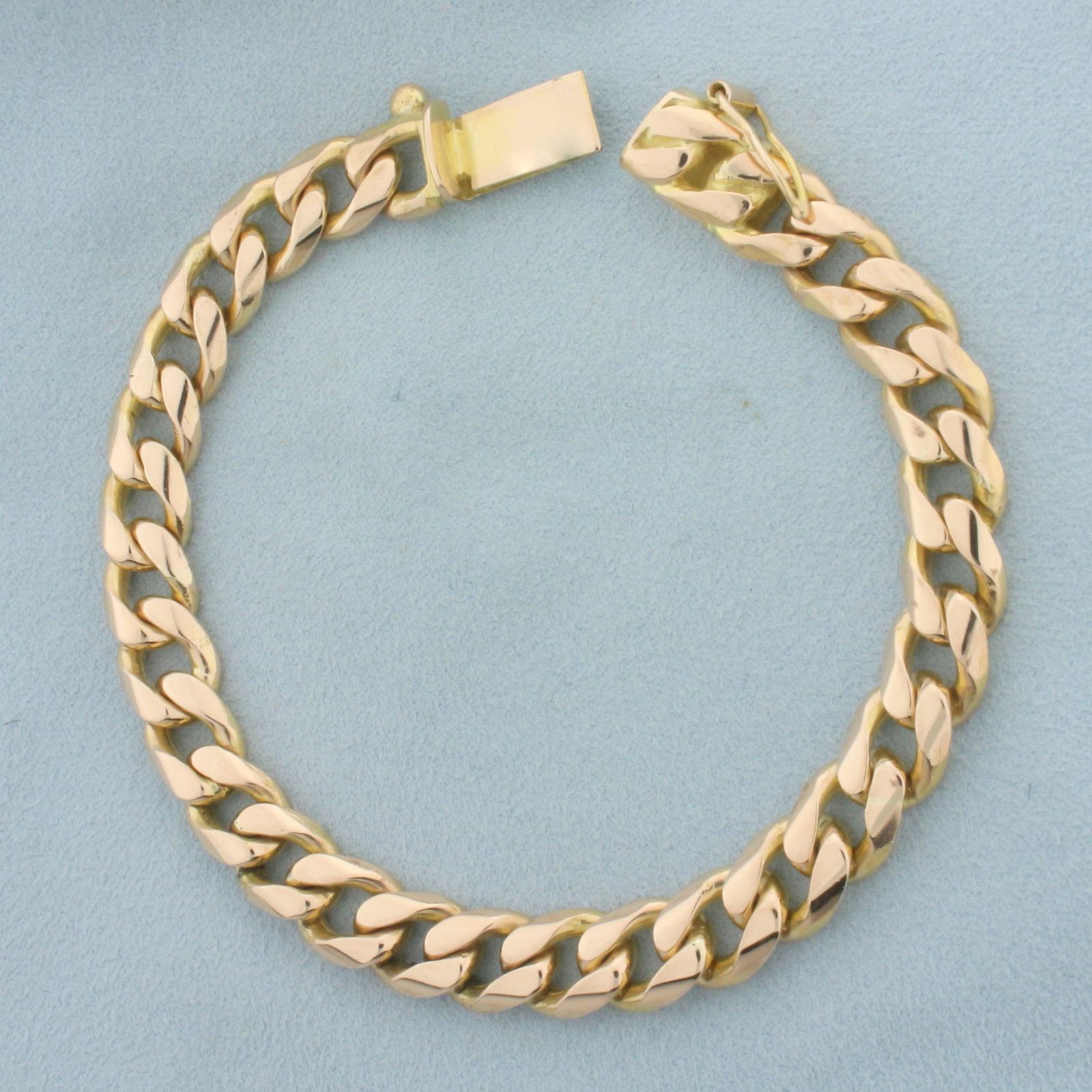 Mens heavy Cuban Curb Link Bracelet in 14k Yellow Gold: In 14k yellow gold. 8.5 inches long, 9.5mm wide. Concealed slide clasp with safety latch. 57.3g.