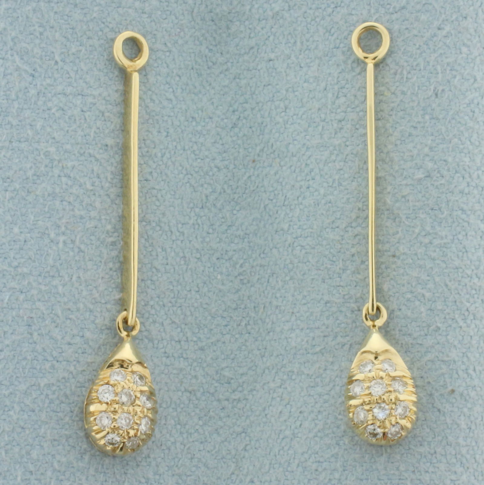 Diamond Teardrop Stud Earring Jacket Enhancers in 14k Yellow Gold: In 14k yellow gold. Contains 20 high quality 1/2pt diamonds. 1 1/4 inches long x 1/4 inch wide.