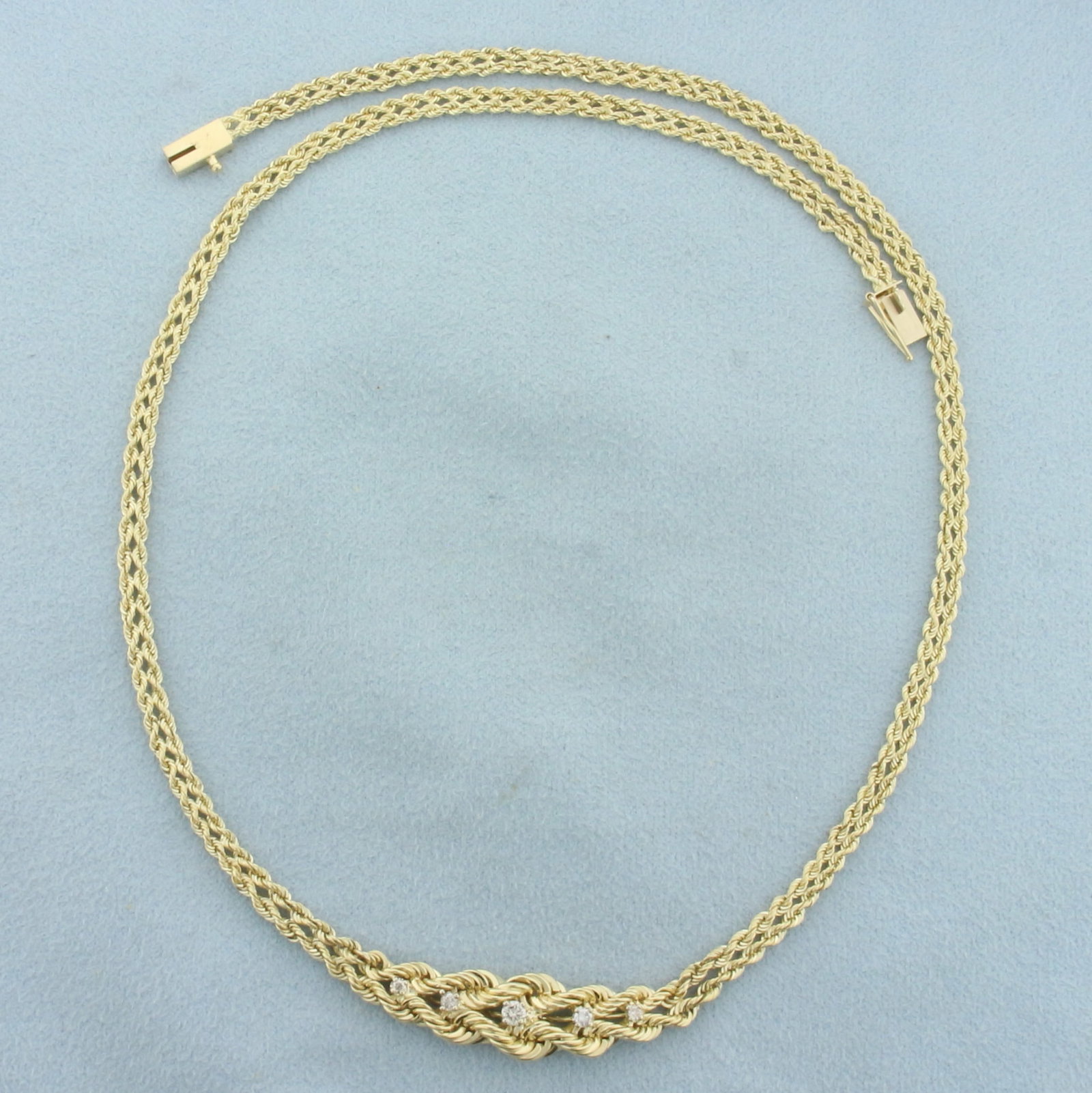 16 Inch Diamond Braided Rope Necklace in 14k Yellow Gold: In 14k yellow gold. Contains one .06ct, two .03ct, and two .02ct high quality diamonds, VS clarity/G color. Double rope link chain is 16 inches long and 3.3mm wide expanding to 9.4mm wide at base. Sli