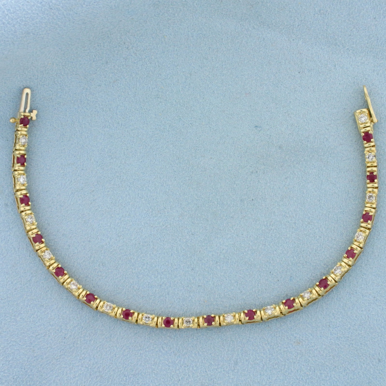 2.5ct TW Ruby and Diamond Tennis Bracelet in 14K Yellow Gold: In 14K Yellow Gold. Contains sixteen high quality natural 3mm ruby gemstones with vibrant red color. Also contains sixteen high quality .07ct round brilliant cut Diamonds, J color/I clarity. 7 1/4 inc