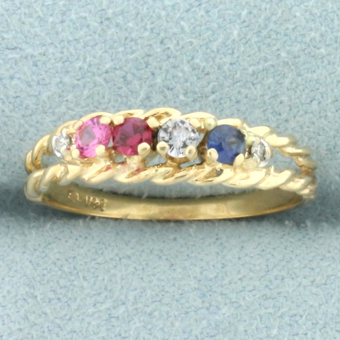 Rainbow Gemstone Rope Ring in 14k Yellow Gold: In 14k yellow gold. Contains four high quality 2.5mm gemstones with vibrant color pink sapphire, ruby, aquamarine, and blue sapphire. Also contains two high quality y1/2pt diamonds. Size: 7. 1.6g.