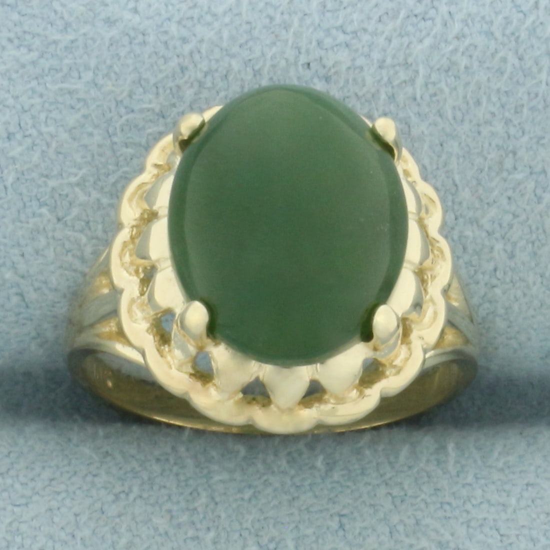Jade Solitaire Ring in 10k Yellow Gold: In 10k yellow gold. Contains one high quality natural 12mm by 10mm jade gemstone, approximately 4ct, with deep color and excellent clarity. Size: 6. 3.6g.